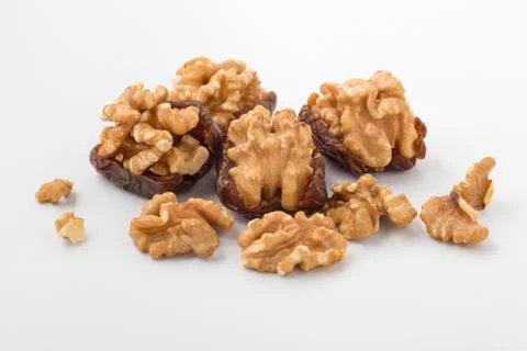 Walnuts in date fruit with walnuts on white background Stock Photos