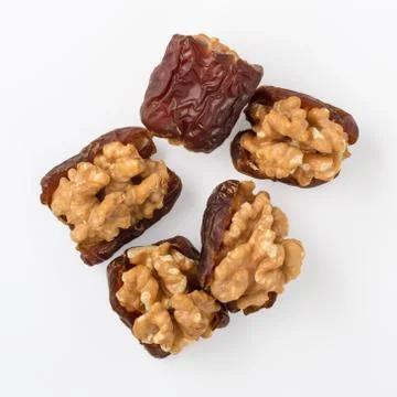 Walnuts with dried date fruit isolated on white background, healthy snack 库存照片