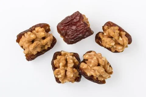 Walnuts with dried dates isolated on white background, top view Stock Photos