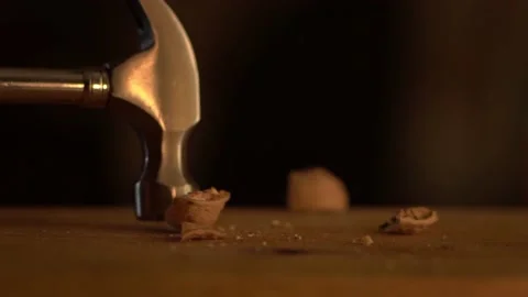 Walnuts explode under the blow of a hammer Stock Footage 193726168