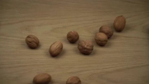 Walnuts Fall And Fill Screen. Organic Walnuts falling on wooden background. Stock Footage 130918399
