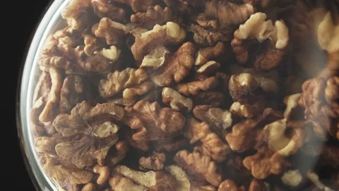 Walnuts fall into a jar, rotate. Nutrient-rich foods. Stock Footage 144114135
