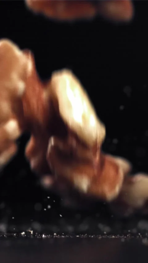 Walnuts fall on the table. Filmed on a high-speed camera at 1000 fps Stock Footage 335308473