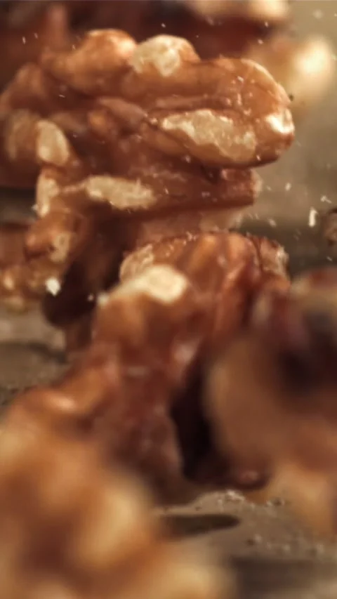 Walnuts fall on the table. Filmed on a high-speed camera at 1000 fps Stock Footage 335320243