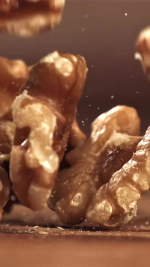 Walnuts fall on the table. Filmed on a high-speed camera at 1000 fps Stock Footage 335320725