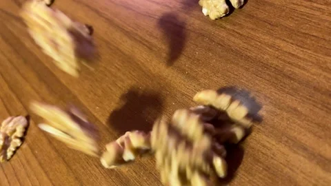 Walnuts fall on the table in slow motion Stock Footage 220740683