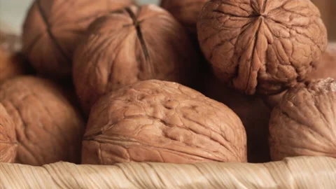 Walnuts falling close-up in a basket in slow motion Stock Footage 152175624