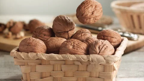 Walnuts falling close-up in a basket in slow motion Stock Footage 152175637
