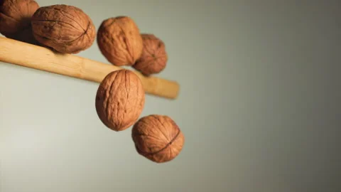 Walnuts falling from a cutting board Stock Footage 152175972