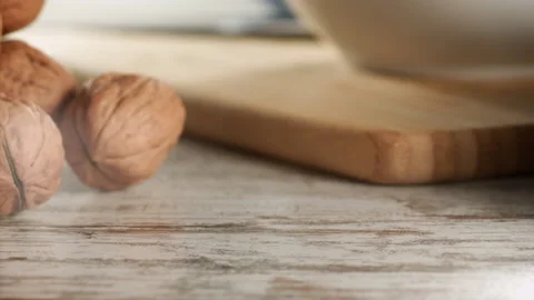 Walnuts falling on a wooden table in slow motion Stock Footage 152175483