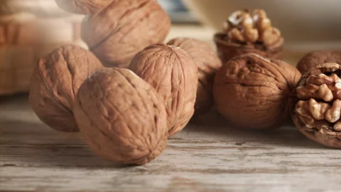 Walnuts falling on a wooden table in slow motion Stock Footage 152175555