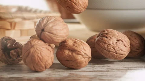 Walnuts falling on a wooden table in slow motion Stock Footage 152175563