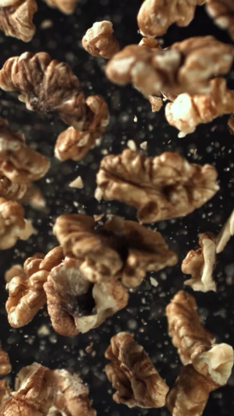 Walnuts fly up and fall down. Filmed on a high-speed camera at 1000 fps Stock Footage 335372362