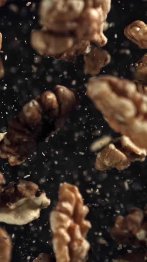 Walnuts fly up and fall down. Filmed on a high-speed camera at 1000 fps Stock Footage 335375171