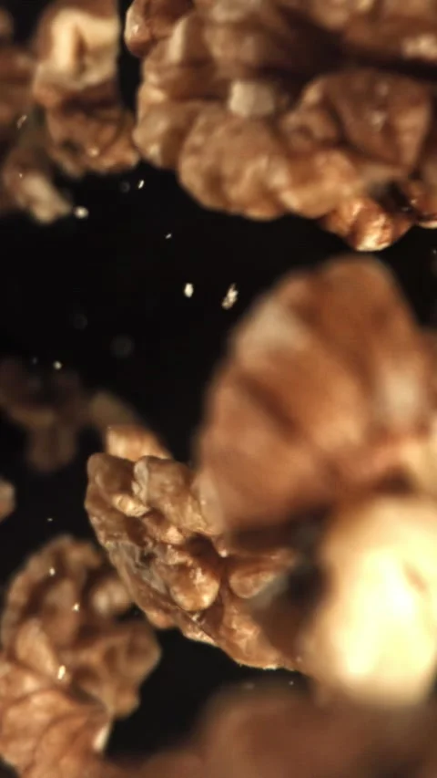 Walnuts fly down. Filmed on a high-speed camera at 1000 fps Stock Footage 335380577