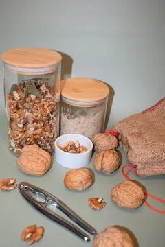 Walnuts in Glass Jars with Nutcracker and Burlap Bag Stock Photos
