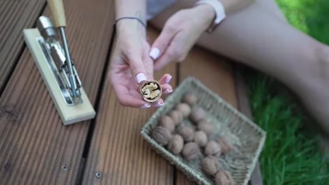 Walnuts in hands. Healthy peeled nuts. Female hand picking a walnut Video stock 246661136
