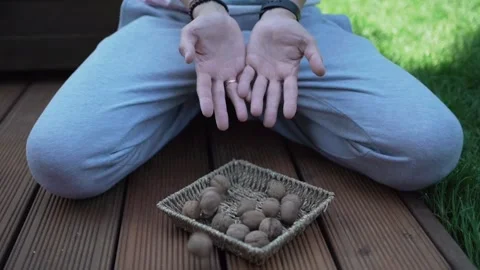 Walnuts in hands. Healthy peeled nuts. male hand picking a walnut Video stock 246661177