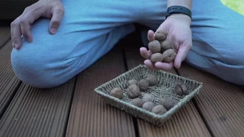 Walnuts in hands. Healthy peeled nuts. male hand picking a walnut Video stock 246661183