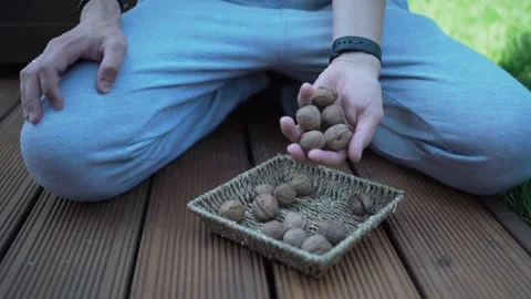Walnuts in hands. Healthy peeled nuts. male hand picking a walnut Video stock 246661320