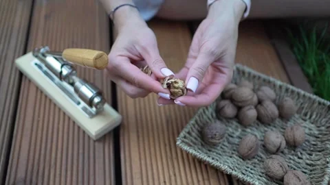 Walnuts in hands. Healthy peeled nuts. Female hand picking a walnut Video stock 246661590