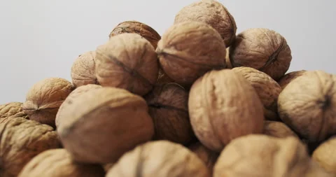 Walnuts with hard textured shells in a heap, side view, fast rotation, seamless Stock Footage 281935186