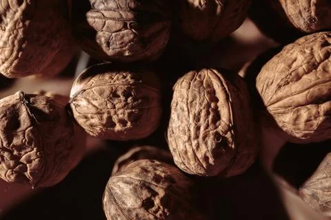 A walnuts heap close-up. Copy space. Beautiful still life on a dark backgroun Stock Photos