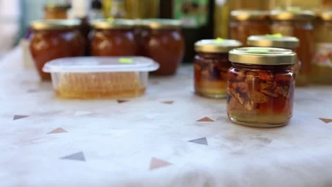 Walnuts in honey displayed in glass jars among homemade artisan preserves Stock Footage 341557177