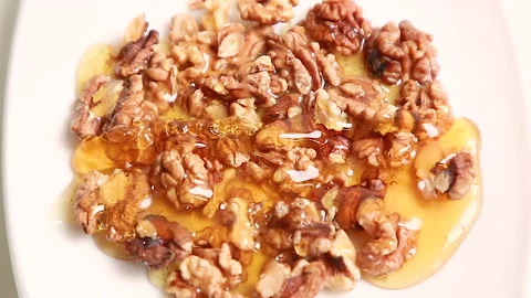 Walnuts with honey Stock Footage 146864250