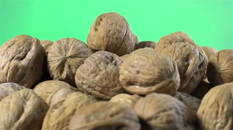 Walnuts isolated rotating on green background Stock Footage 62399338