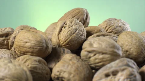 Walnuts isolated rotating on green/gray background Stock Footage 62399585