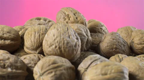 Walnuts isolated rotating on pink background Stock Footage 62399921