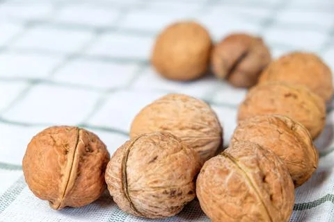 Walnuts isolated on a white towel.Space for text Stock Photos