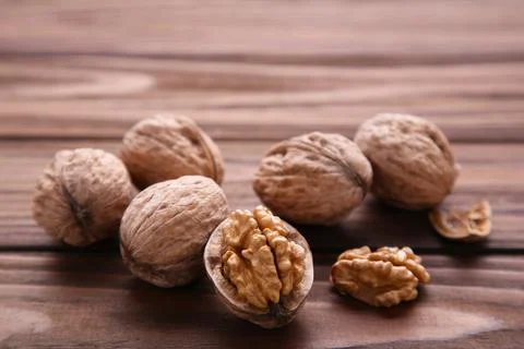 Walnuts kernels on brown wooden background. Walnut healthy food Stock Photos