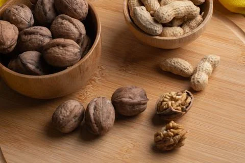 Walnuts kernels on dark desk with color background, Whole walnut in wood vint Stock Photos