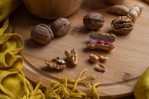 Walnuts kernels on dark desk with color background, Whole walnut in wood vint Stock Photos