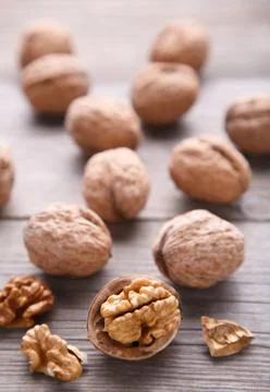 Walnuts kernels on grey wooden background. Walnut healthy food Stock Photos