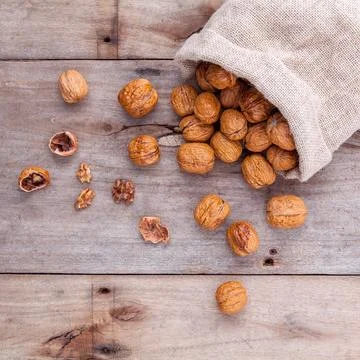Walnuts kernels on rustic old wooden background. Stock Photos