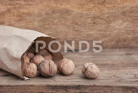 Walnuts in a kraft paper bag Stock Photos