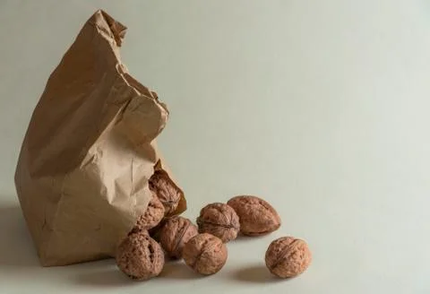 Walnuts leaking from a paper bag Stock Photos