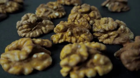 Walnuts lie on a black table and on top are filled with hot chocolate Stock Footage 147255465