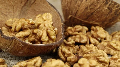 Walnuts lie in half a coconut shell Stock Footage 124133059