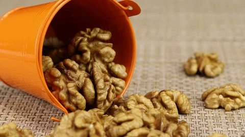 Walnuts lie in an orange bucket Stock Footage 124133067