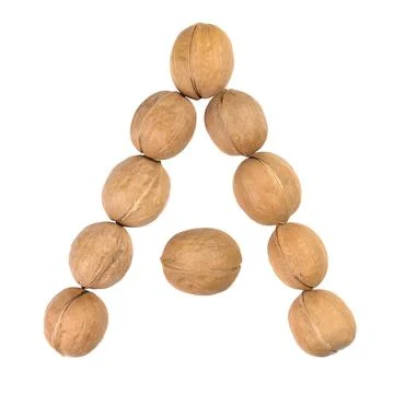Walnuts lined in the shape of the letter "A" isolated on white Stock Photos