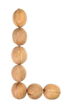 Walnuts lined in the shape of the letter "L" isolated on white Stock Photos