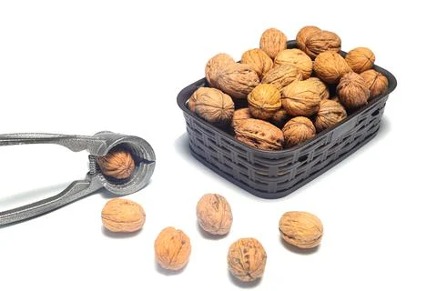 Walnuts with nutcracker isolated on white background Stock Photos