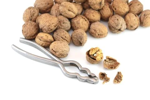 Walnuts with nutcracker Stock Photos