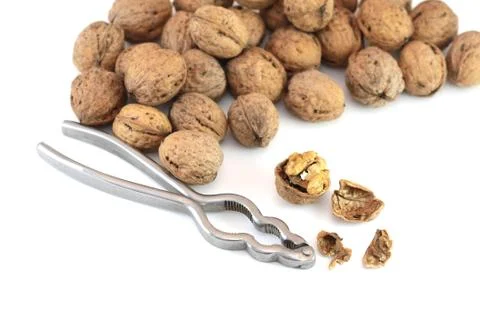 Walnuts with nutcracker Stock Photos