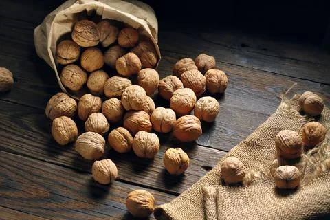 Walnuts on an old rustic table. Walnuts in a paper bag.walnuts on a jute napk 写真素材