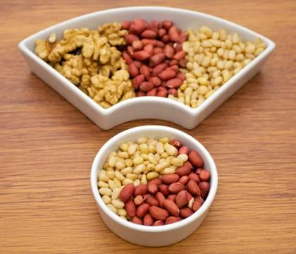 Walnuts, peanut and pine nut Stock Photos